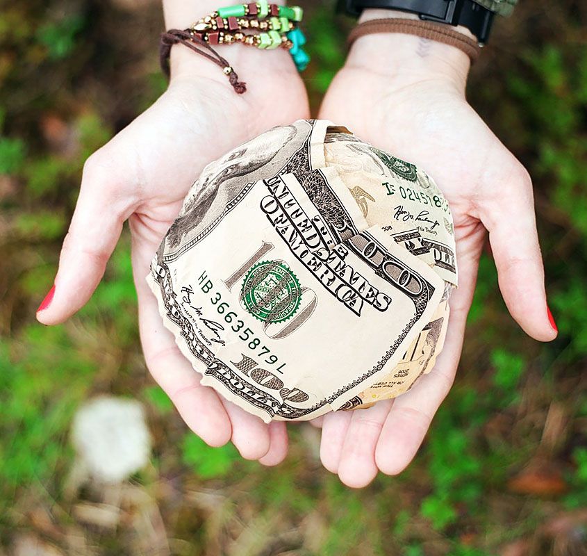 Hands Holding Money Ball